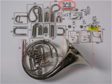 Detailed diagram of a French horn with labeled parts on a white background